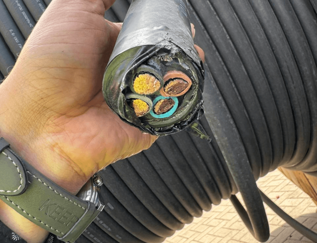 Scrap Submarine Cable Buyer in Dubai – Used decommissioned submarine cables with worn insulation in an industrial scrapyard.